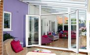 White UPVC contemporary gable end Veranda conservatory with French doors opening onto veranda space from Anglian Home Improvements