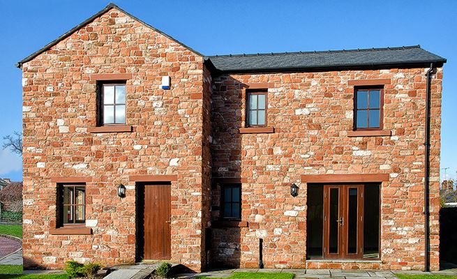 Whole house double glazed wooden windows and doors finished in Dark woodgrain from Anglian Home Improvements