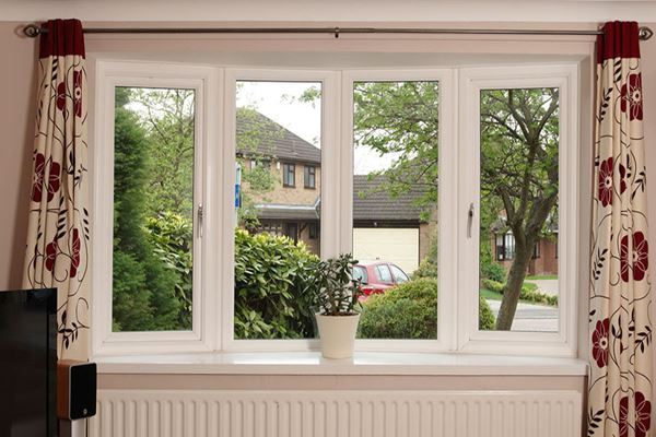 Curved UPVC bay window with double glazing finished in White from the Anglian bay window range