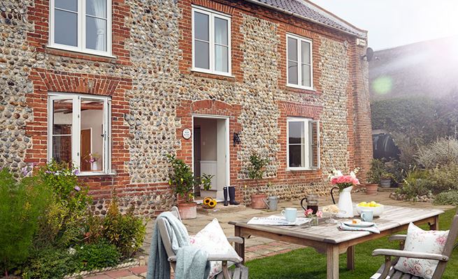 Whole house replacement double glazing timber casement windows with Georgian bars finished in white from the Anglian wooden windows range
