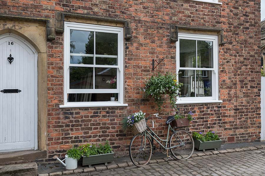 White wooden sliding sash windows at front of house