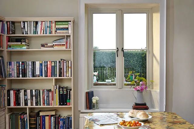 Cottage style wooden window finished in white with central mullion from Anglian Home Improvements